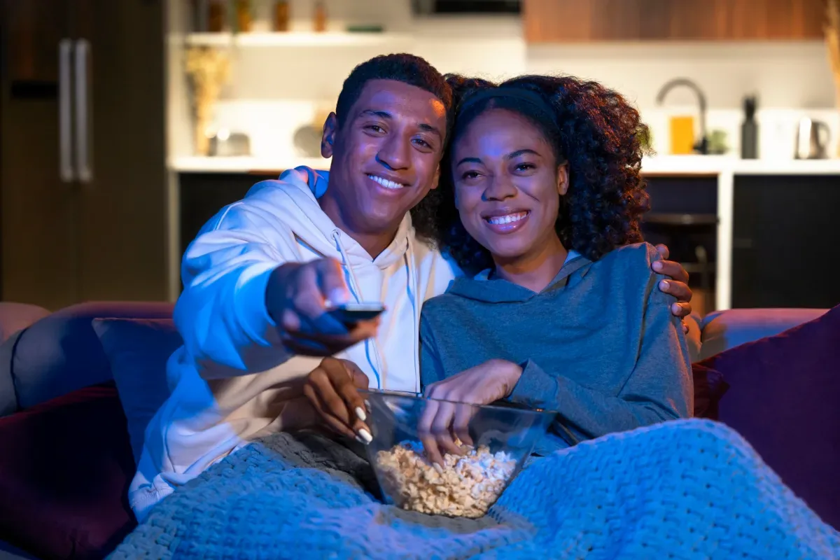 Couple sharing popcorn during a movie night