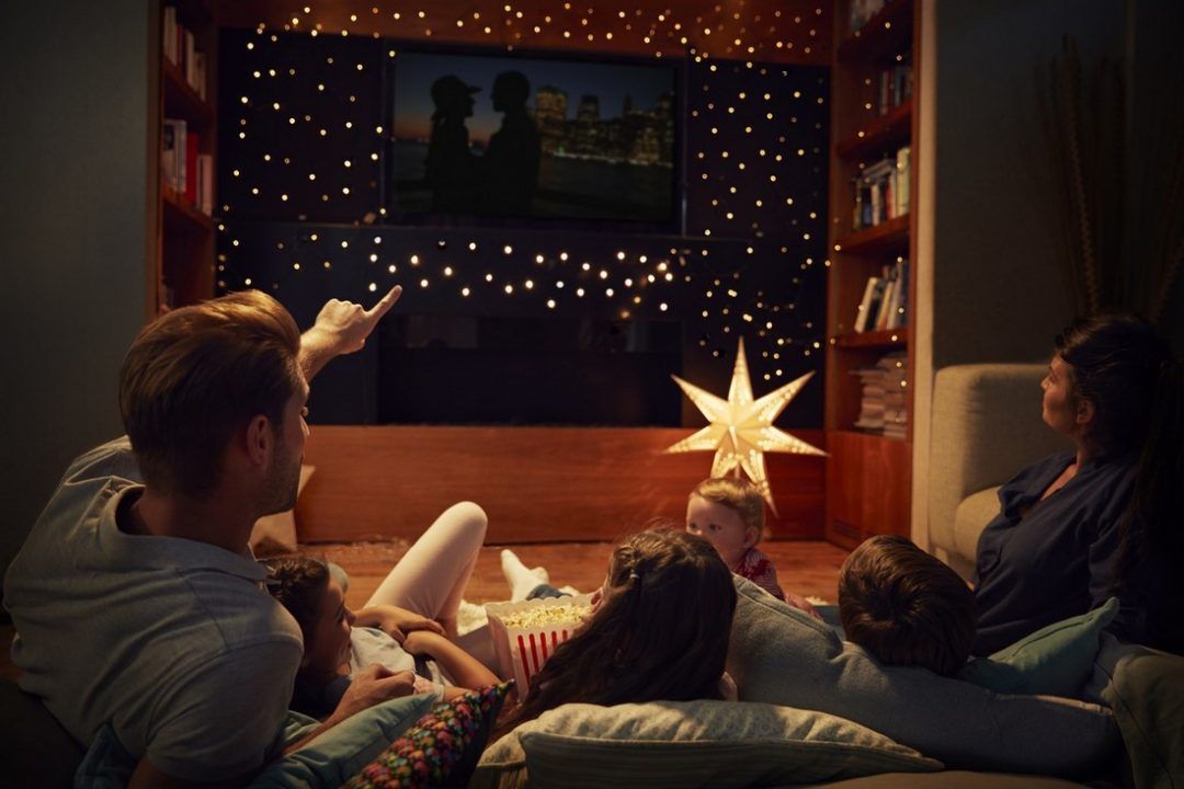 Family enjoying a movie night together at home